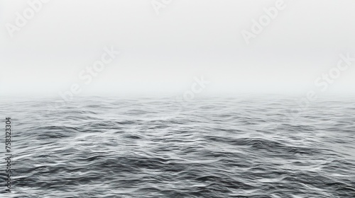 a black and white photo of a body of water with a boat in the middle of the water and a foggy sky in the background. photo