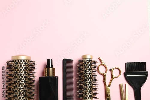 Professional hair dresser tools on pink background, flat lay. Space for text