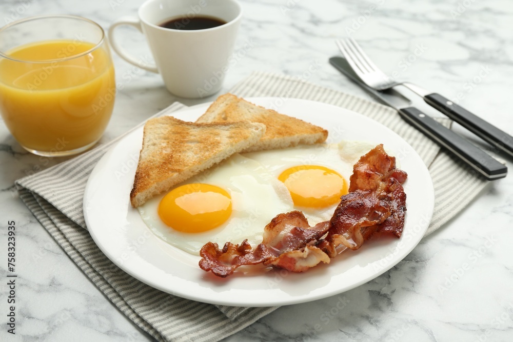 Delicious breakfast with sunny side up eggs served on white marble table, closeup Delicious breakfast with sunny side up eggs served on white marble table, closeup