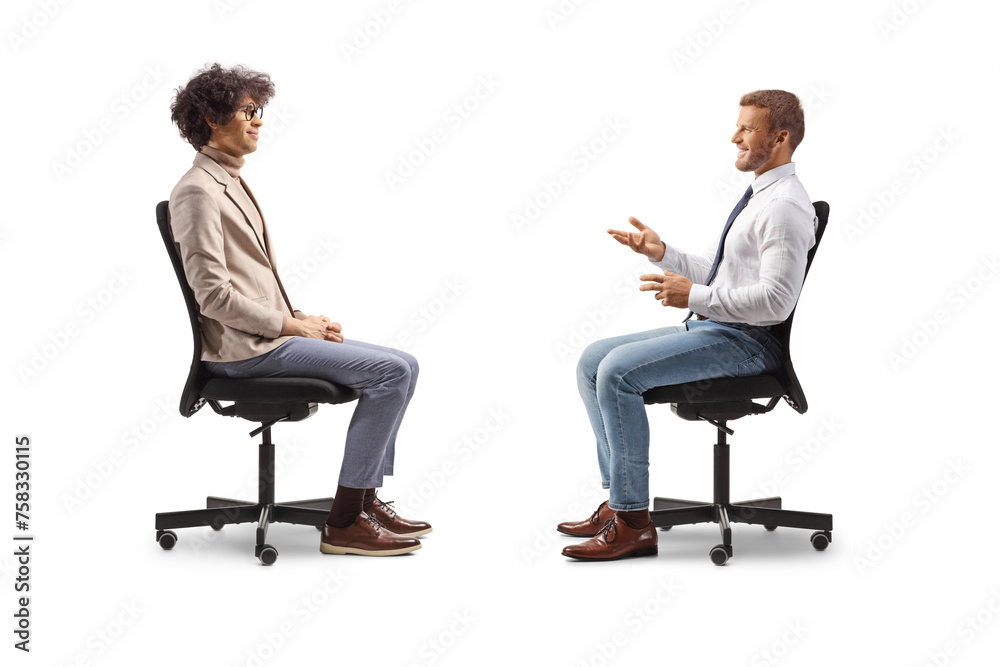 Profile shot of a boss sitting in an office chair and talking to an employee Profile shot of a boss sitting in an office chair and talking to an employee