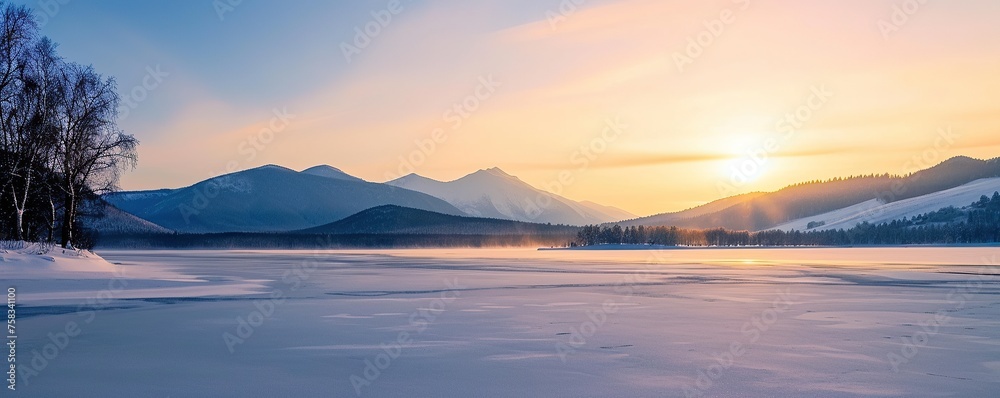 View of a frozen lake with mountains in the background in winter View of a frozen lake with mountains in the background in winter