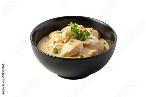 Creamy chicken in a black bowl isolated on transparent background.