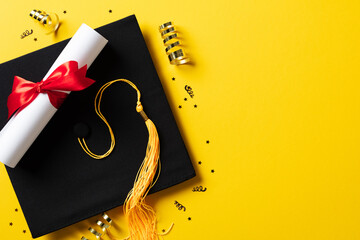 Flat lay composition with graduation hat and diploma on yellow background
