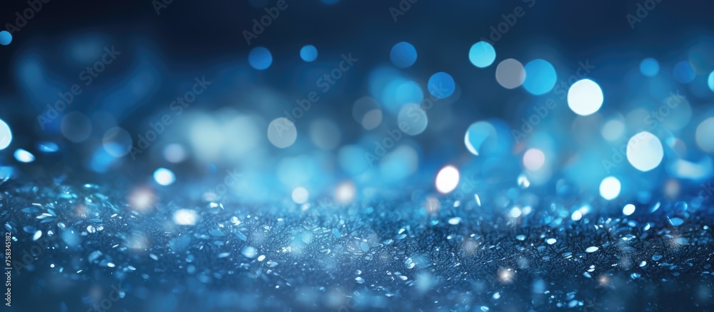 Abstract blue and silver glitter lights with a blurred background.