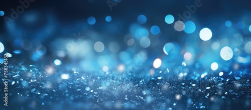 Abstract blue and silver glitter lights with a blurred background.