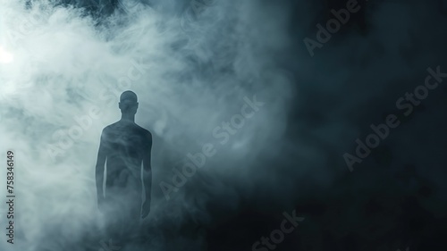 A silhouetted figure emerges within a dense, atmospheric fog