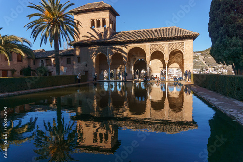Reflection on water surface of El Palacio del Partal or Partal Palace at Alhambra castle, Albaicin old town, Granada, Andalusia, Spain photo