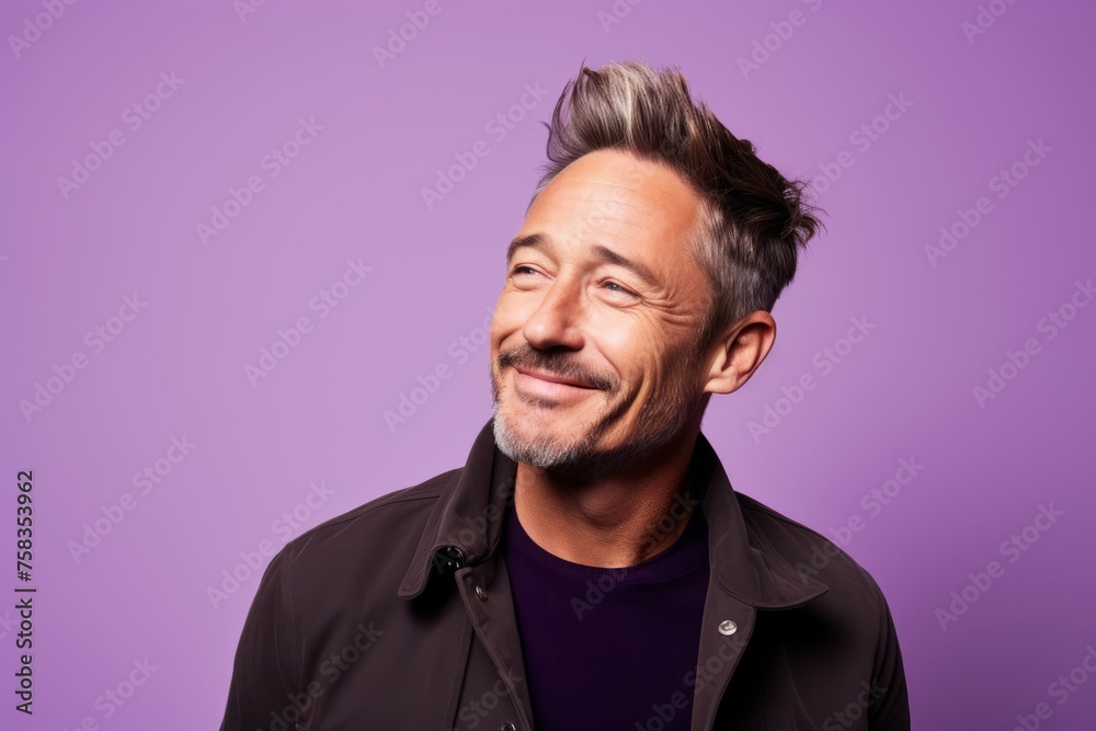 Portrait of a handsome middle aged man with trendy hairstyle on purple background Portrait of a handsome middle aged man with trendy hairstyle on purple background