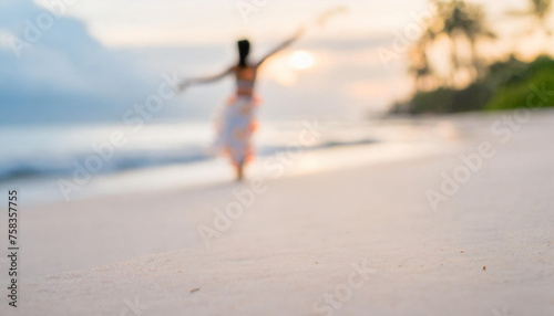 A woman hula dances on a tropical beach.
