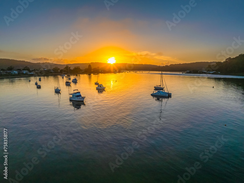 A fresh new day - sunrise waterscape with boats in the channel