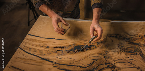 production of handmade tables made of solid wood with epoxy resin