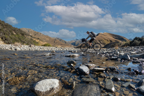 Biking in the backcountry of New Zealand with mountain landscape near Queenstown