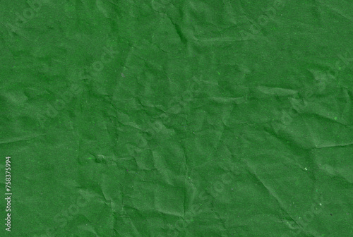 Seamless crumpled dark green kraft paper texture. Empty textured sheet.