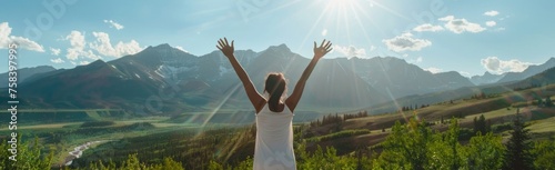 A person wearing white , standing with their arms raised towards the sky and mountains in front of them Generative AI