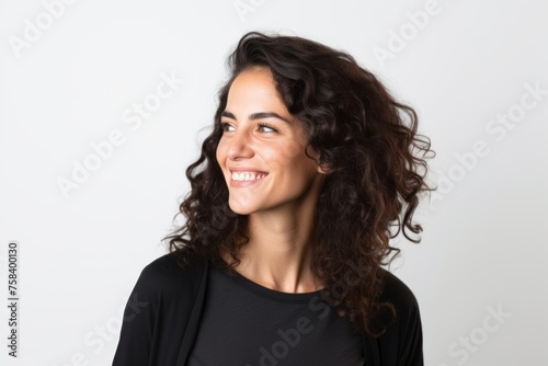 Portrait of a beautiful woman with long wavy hair smiling.