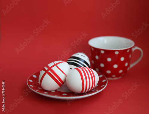 Easter composition. Easter eggs on a saucer on a red background.