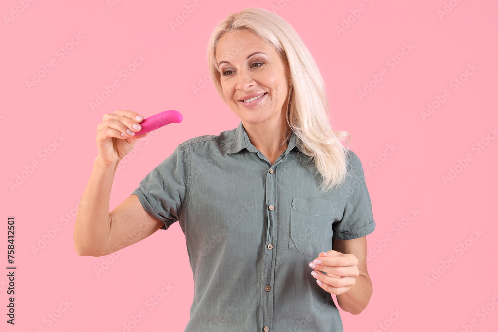 Mature woman with vibrator on pink background Mature woman with vibrator on pink background