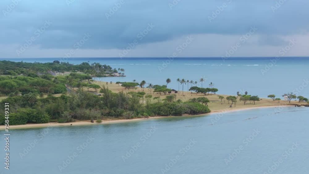 Aerial view of Kualoa Regional park on overcast day. Cinematic nature landscape on Oahu Island coastline. Hawaii beautiful nature. Secret beach on tropical island. Favorite summer vacation destination Aerial view of Kualoa Regional park on overcast day. Cinematic nature landscape on Oahu Island coastline. Hawaii beautiful nature. Secret beach on tropical island. Favorite summer vacation destination