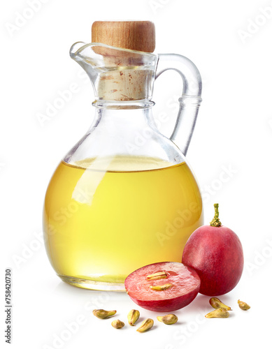 Bottle of grape seed oil and fresh ripe grapes with seeds