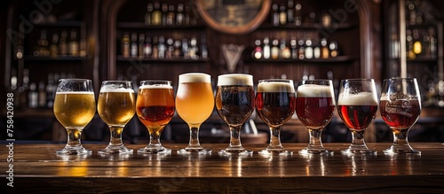 A row of drinkware filled with various types of alcoholic beverages, including cognac, Disaronno, and beer, is displayed on the bar photo