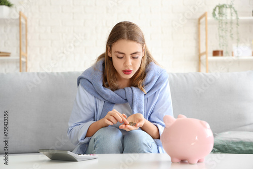 Young woman counting coins ...