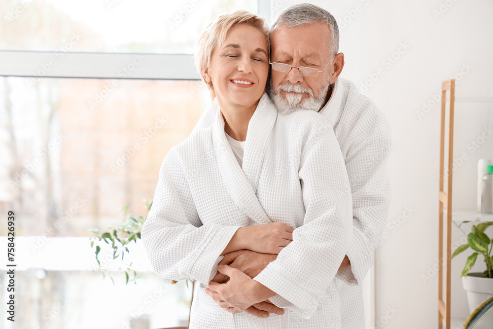 Mature couple hugging after shower in bathroom Mature couple hugging after shower in bathroom