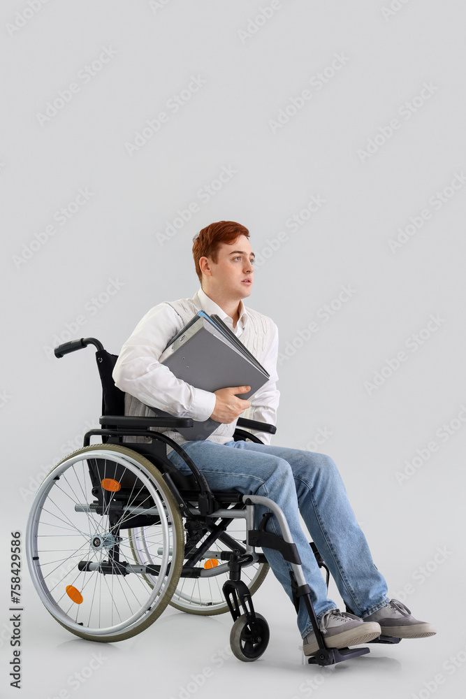 Office worker in wheelchair with folders on light background Office worker in wheelchair with folders on light background