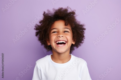 Close up portrait of a happy african american little girl, isolated on violet background