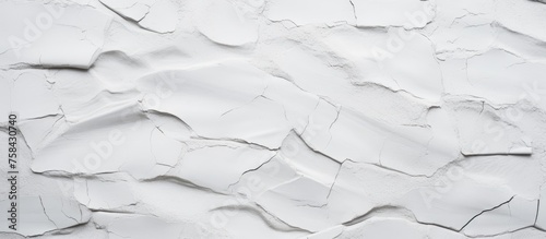 A closeup shot of a white wall with a cracked texture resembling a snowy landscape. The monochrome pattern gives a freezing effect to the flooring