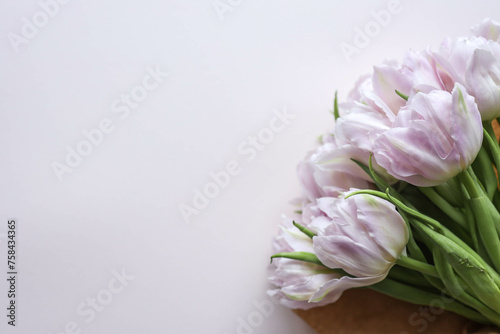 Bouquet of pink tulips on pastel background. Mothers day, Valentines Day, Birthday celebration concept. Greeting card. Copy space for text, top view