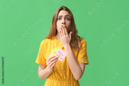 Excited young woman holding...