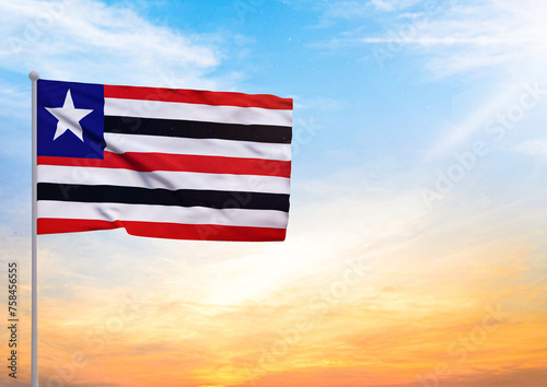 3D illustration of a Maranhao flag extended on a flagpole and in the background a beautiful sky with a sunset