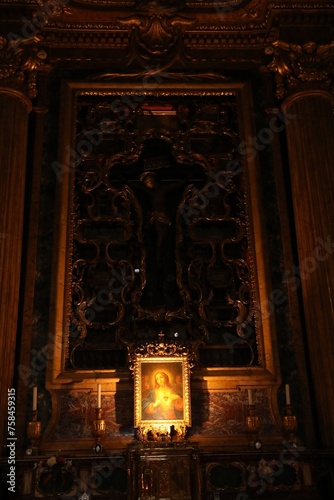 Rome, Italy - February 3, 2024: Ornate cross design of cruxification of Christ above altar. Church of St. Ignatius of Loyola at Campus Martius photo