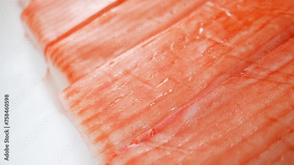 Originating in East Asia, surimi is made from whitefish like pollock, hake, or cod. Ground into paste, mixed with starch, egg white, salt, sugar, flavorings for texture, taste, shelf life. 4K. Originating in East Asia, surimi is made from whitefish like pollock, hake, or cod. Ground into paste, mixed with starch, egg white, salt, sugar, flavorings for texture, taste, shelf life. 4K.