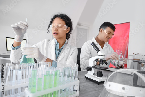 Chemists working at table in laboratory