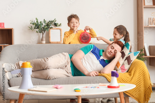 Bild auf Leinwand Little children planning to prank their sleeping father with whoopee cushion at home