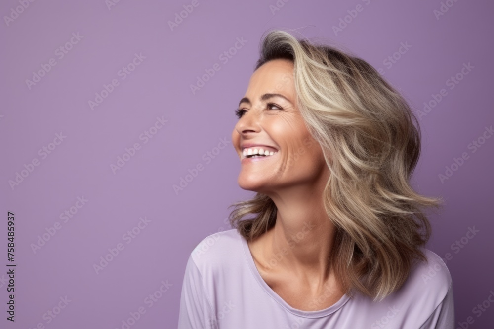 Portrait of a happy young woman with blond hair on purple background Portrait of a happy young woman with blond hair on purple background