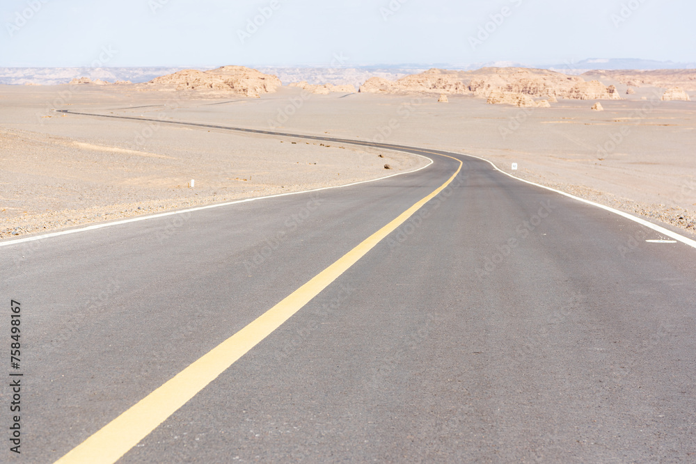 Tourist road in the Devil City in Hami, Xinjiang, China Tourist road in the Devil City in Hami, Xinjiang, China