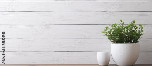 Front view of plant and flower mock-up in white flowerpot on wooden desk in front of white brick wall texture background © Vusal