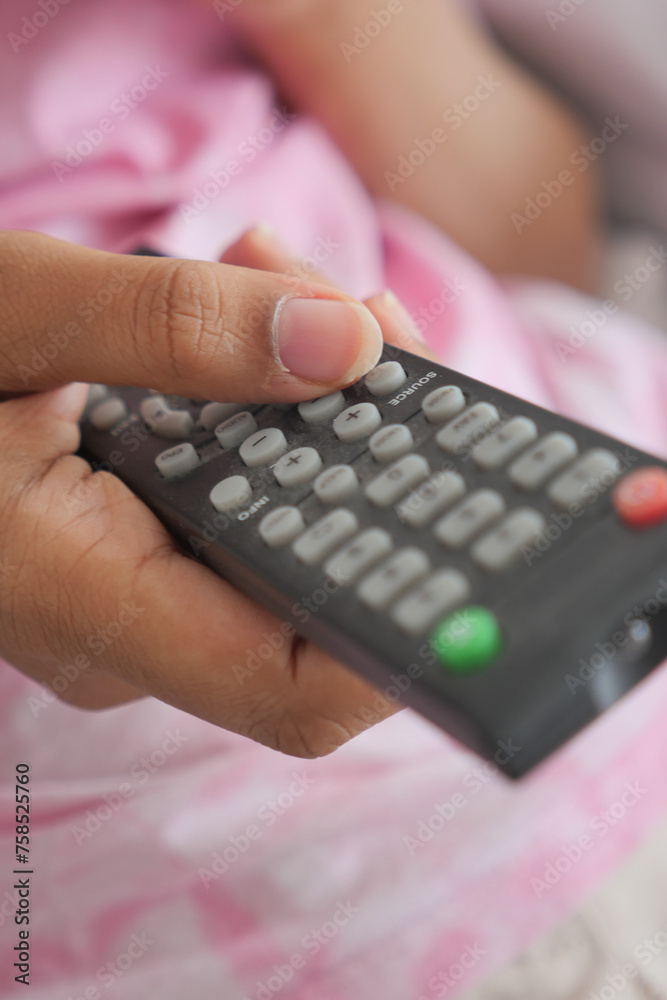 close up of women hand holding tv remote. close up of women hand holding tv remote.