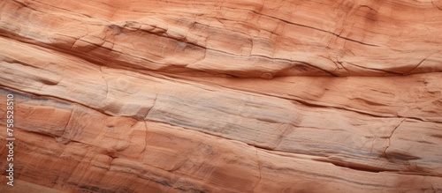 A detailed closeup of a bedrock outcrop, displaying intricate formations and textures resembling hardwood. The terrain shows fault lines and wood stainlike patterns