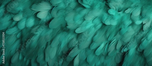 A closeup of a textured green feather with electric blue highlights resembling a woolen knitting pattern. The unique design is reminiscent of marine biology art with hints of fur and rock formations © TheWaterMeloonProjec