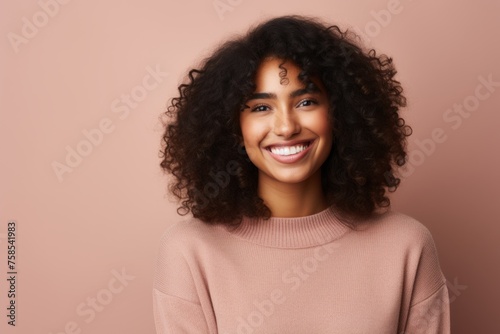 Beautiful african american woman with curly hair on pink background