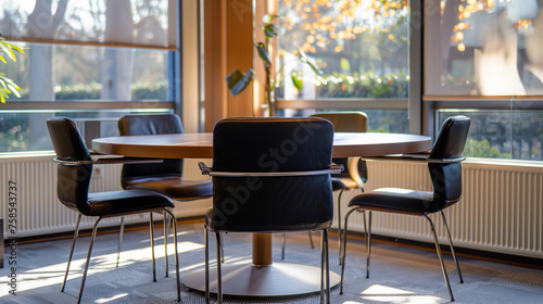Sunlit conference room in a law office, with a round table and chairs for client meetings
