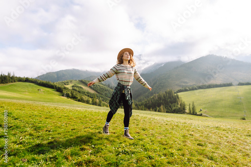 Woman tourist in a hat backpack travel mountains relaxation. Traveler enjoying nature. Adventures.