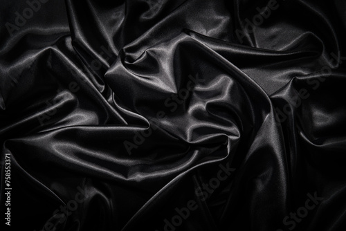 ドレープのある黒いサテンの布地の背景テクスチャー photo