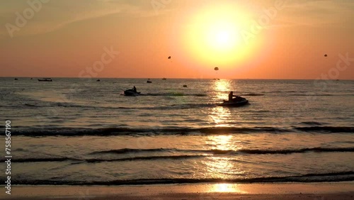 Langkawi island in Malaysia, Chenang beach in the evening, people walk along the beach
