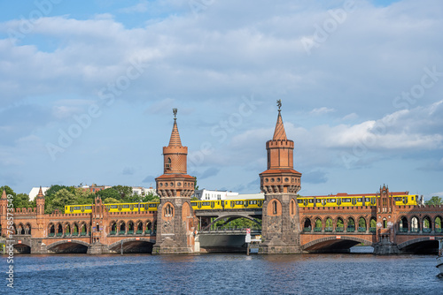 The beautiful Oberbaumbruecke in Berlin with a yellow subway train © elxeneize