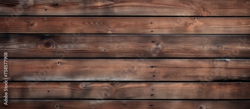 A close up of a hardwood plank wall with a brown wood stain, creating a beautiful pattern resembling brickwork. The blurred background adds depth to the rectangular shapes