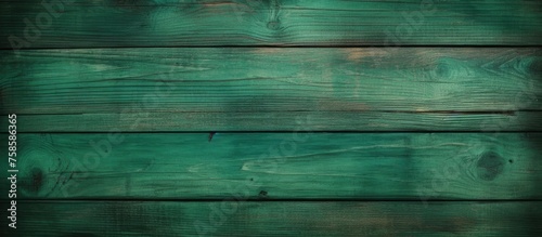 Close up of a patterned green wooden surface, highlighting tints and shades of aqua and electric blue. Symmetrical rectangles showcase the natural beauty of wood, resembling an artistic masterpiece
